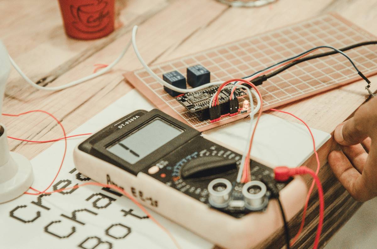 Close-up of kill switch device test setup with oscilloscope measuring power cutoff latency